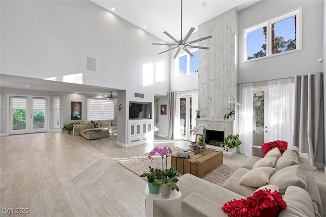 5125 Turnberry Ln, Las Vegas, NV 89113 - living area featuring a towering ceiling, a ceiling fan, wood finished floors, and plenty of natural light