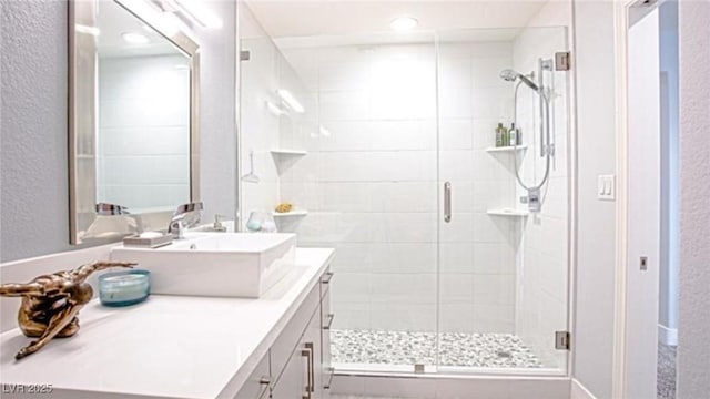 5125 Turnberry Ln, Las Vegas, NV 89113 - bathroom with vanity, a textured wall, and a shower stall