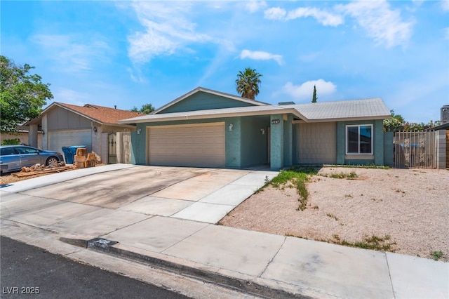 508 Purcell Dr, Las Vegas, NV 89107 - ranch-style home featuring a garage, driveway, fence, and stucco siding