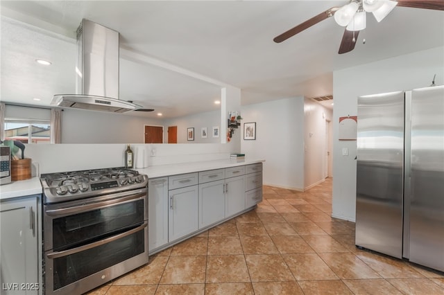 508 Purcell Dr, Las Vegas, NV 89107 - kitchen with stainless steel appliances, island exhaust hood, gray cabinets, ceiling fan, and light countertops