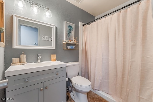 508 Purcell Dr, Las Vegas, NV 89107 - bathroom featuring a textured wall, toilet, vanity, and a shower with shower curtain