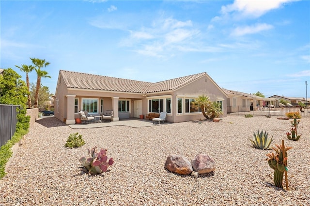2069 Colvin Run Dr, Henderson, NV 89052 - back of property featuring a tile roof, a fenced backyard, stucco siding, and a patio area