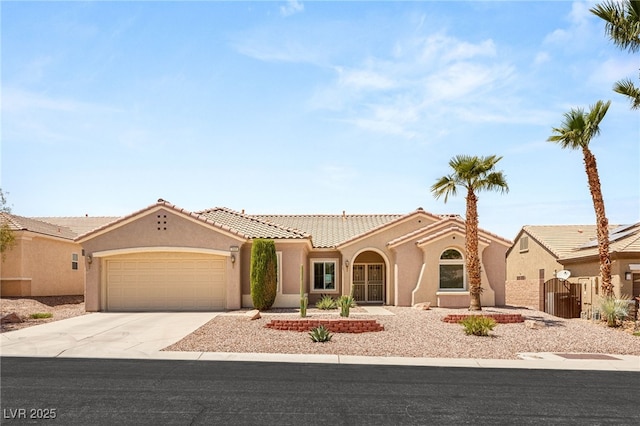 2069 Colvin Run Dr, Henderson, NV 89052 - mediterranean / spanish-style home featuring driveway, stucco siding, an attached garage, and a tile roof