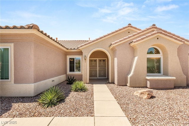 2069 Colvin Run Dr, Henderson, NV 89052 - doorway to property with stucco siding and a tile roof