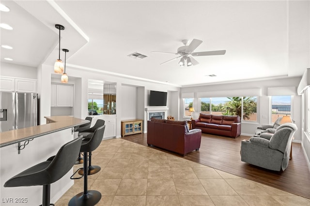 2069 Colvin Run Dr, Henderson, NV 89052 - living room with light tile patterned floors, a ceiling fan, a fireplace, and recessed lighting