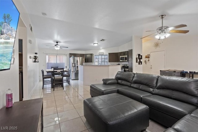 5184 Mineral Lake Dr, Las Vegas, NV 89122 - living room with a ceiling fan, light tile patterned floors, plenty of natural light, and baseboards