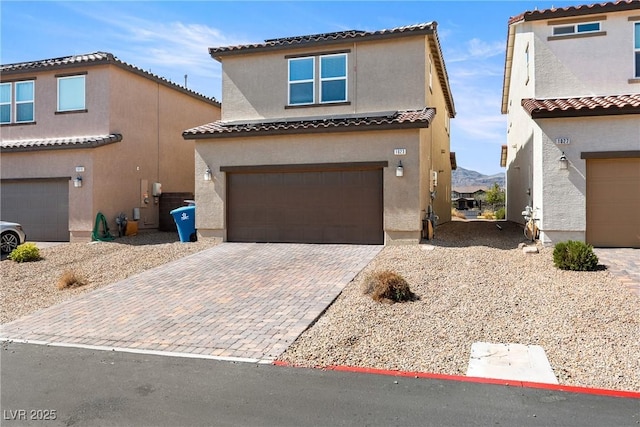 1023 Brilliant Meadow Ave, North Las Vegas, NV 89086 - mediterranean / spanish-style home with a garage, stucco siding, a tiled roof, and decorative driveway