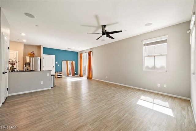 1023 Brilliant Meadow Ave, North Las Vegas, NV 89086 - unfurnished living room featuring ceiling fan, light wood finished floors, baseboards, and recessed lighting