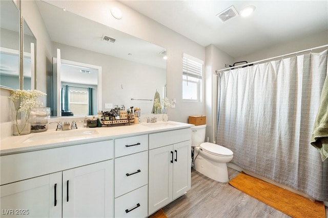 1023 Brilliant Meadow Ave, North Las Vegas, NV 89086 - full bath with toilet, double vanity, wood finished floors, and a shower with shower curtain