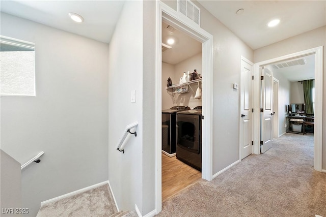 1023 Brilliant Meadow Ave, North Las Vegas, NV 89086 - hall with washer and dryer, light carpet, baseboards, and an upstairs landing