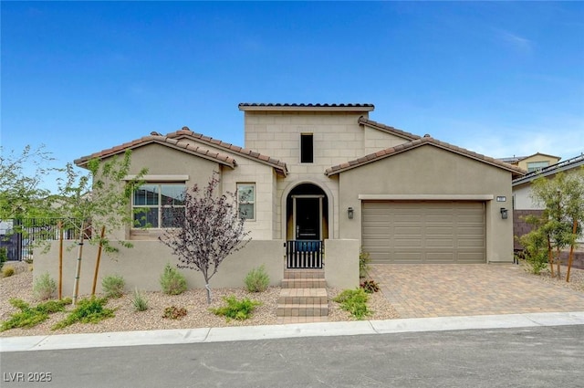 281 Gandara St, Las Vegas, NV 89138 - mediterranean / spanish house featuring an attached garage, a tiled roof, driveway, and stucco siding