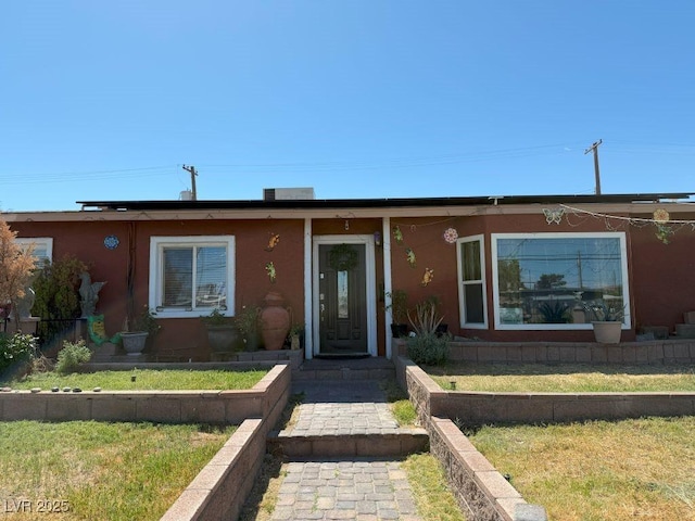 4559 S Nellis Blvd, Las Vegas, NV 89121 - view of front facade featuring a front lawn and stucco siding