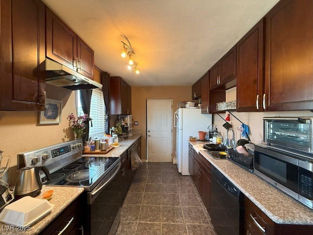 4559 S Nellis Blvd, Las Vegas, NV 89121 - kitchen with stainless steel appliances, a sink, under cabinet range hood, light countertops, and dark tile patterned floors
