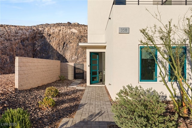 350 Solitude Peak Ln, Henderson, NV 89012 - entrance to property featuring a gate, stucco siding, fence, and a mountain view