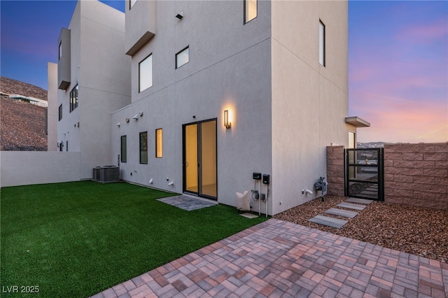 350 Solitude Peak Ln, Henderson, NV 89012 - back of house at dusk featuring a gate and stucco siding