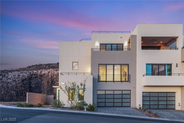 350 Solitude Peak Ln, Henderson, NV 89012 - contemporary home with stucco siding, an attached garage, driveway, and a mountain view
