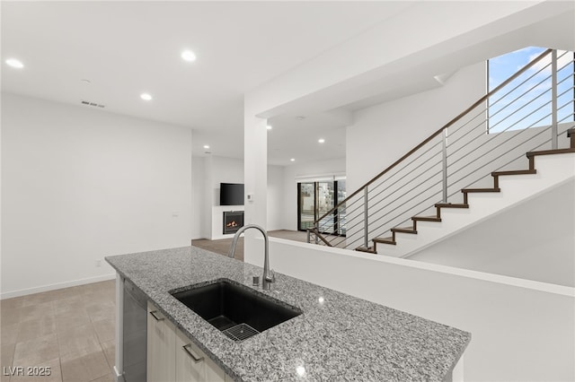 350 Solitude Peak Ln, Henderson, NV 89012 - kitchen with a sink, dishwasher, recessed lighting, healthy amount of natural light, and a lit fireplace