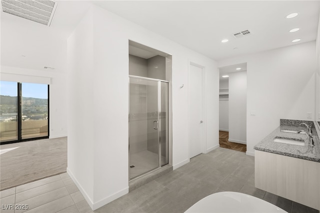 350 Solitude Peak Ln, Henderson, NV 89012 - full bathroom featuring a shower stall, recessed lighting, baseboards, double vanity, and tile patterned floors