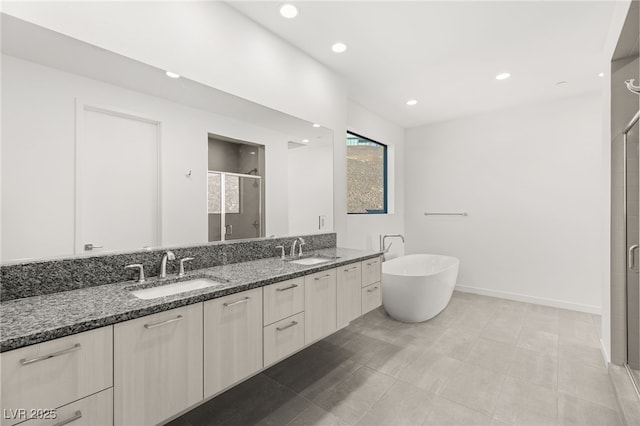350 Solitude Peak Ln, Henderson, NV 89012 - full bathroom featuring a shower stall, double vanity, recessed lighting, a freestanding tub, and baseboards