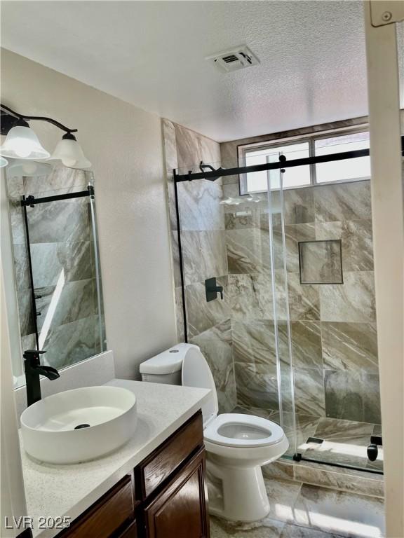 8397 San Ramon Dr, Las Vegas, NV 89147 - bathroom featuring vanity, a shower stall, and toilet