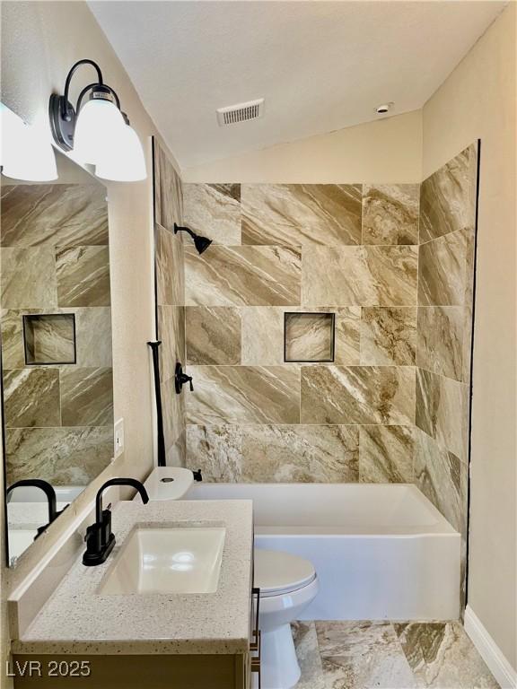 8397 San Ramon Dr, Las Vegas, NV 89147 - bathroom featuring toilet, vanity, and washtub / shower combination