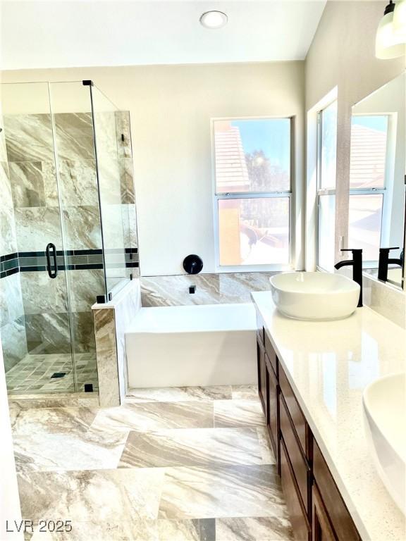 8397 San Ramon Dr, Las Vegas, NV 89147 - bathroom with a garden tub, a stall shower, and double vanity