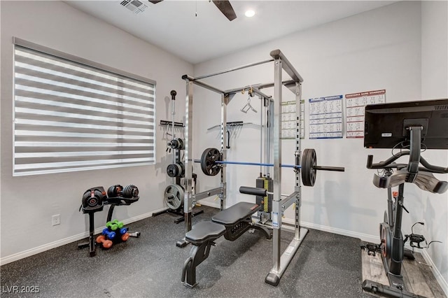 workout area featuring baseboards and a ceiling fan