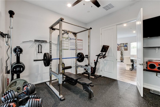 exercise room featuring a ceiling fan and baseboards