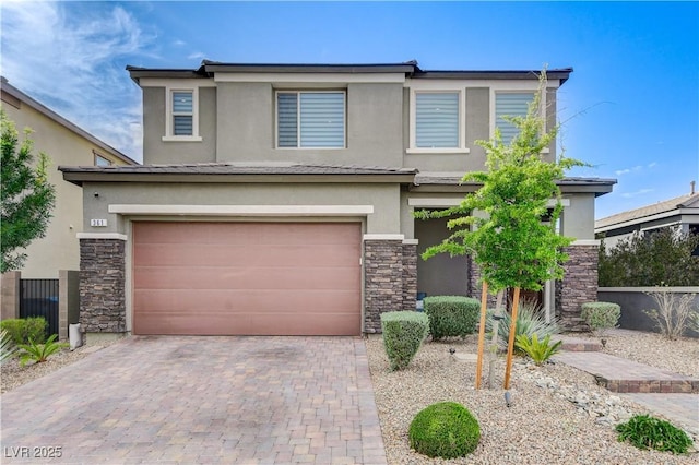 view of front of home featuring stone siding, stucco siding, a garage, and decorative driveway