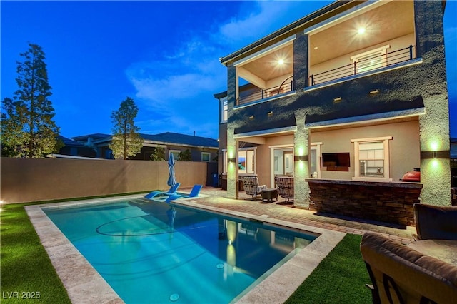 view of swimming pool featuring fence and a patio area