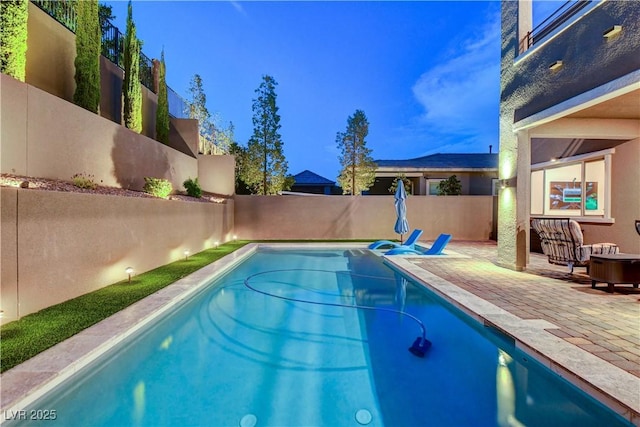 view of swimming pool featuring fence and a patio area