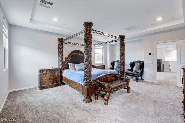 bedroom with carpet floors, a tray ceiling, baseboards, and recessed lighting