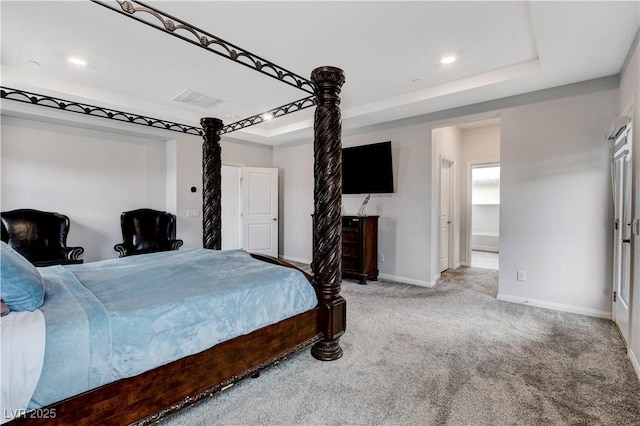 carpeted bedroom featuring a tray ceiling, baseboards, and recessed lighting