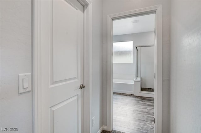 hall with wood finished floors