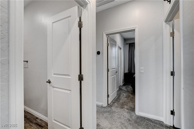 hallway with baseboards and carpet