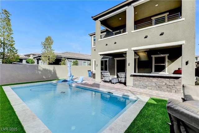 view of pool with fence and a patio