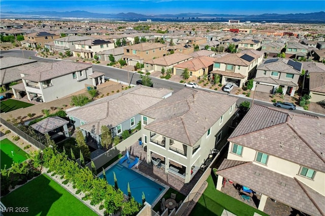 aerial view of residential area featuring a mountain backdrop