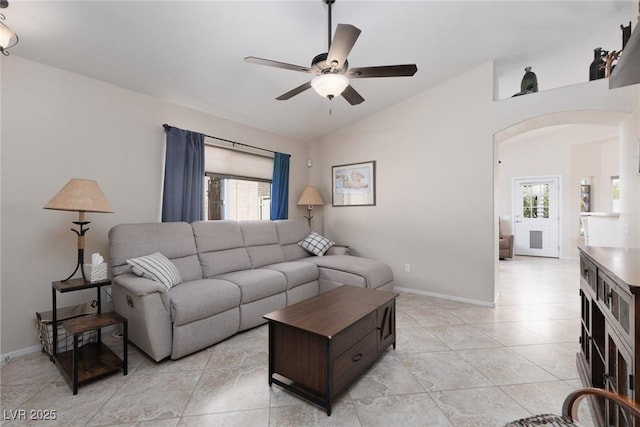 7904 Seabourn Ct, Las Vegas, NV 89129 - living room featuring arched walkways, a ceiling fan, lofted ceiling, light tile patterned floors, and baseboards