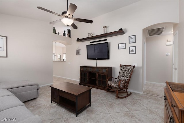 7904 Seabourn Ct, Las Vegas, NV 89129 - living area featuring arched walkways, ceiling fan, light tile patterned flooring, and baseboards