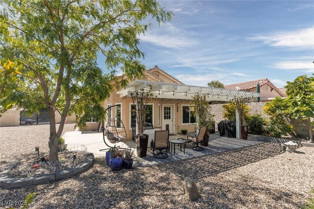 7904 Seabourn Ct, Las Vegas, NV 89129 - back of house featuring fence, a patio, and stucco siding