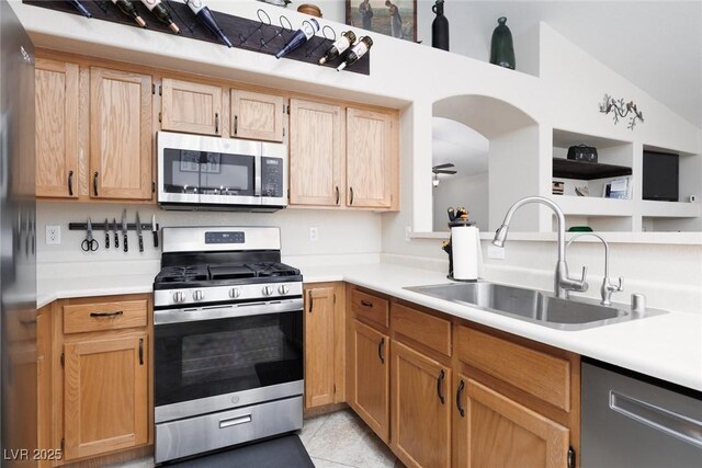 7904 Seabourn Ct, Las Vegas, NV 89129 - kitchen with appliances with stainless steel finishes, a sink, light countertops, ceiling fan, and vaulted ceiling