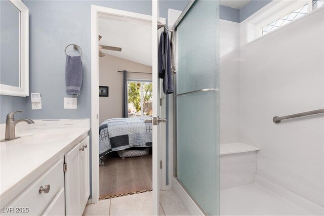 7904 Seabourn Ct, Las Vegas, NV 89129 - full bath with a stall shower, vaulted ceiling, vanity, a ceiling fan, and tile patterned floors