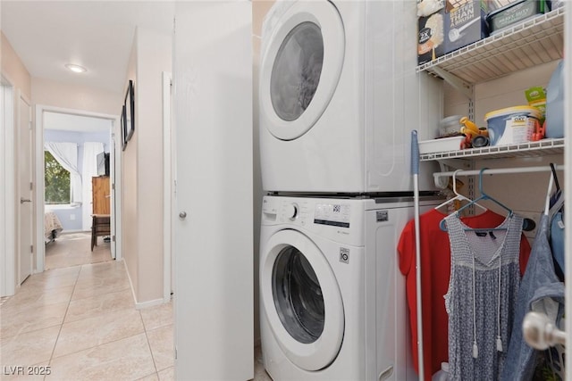 7904 Seabourn Ct, Las Vegas, NV 89129 - washroom featuring stacked washer / dryer, light tile patterned floors, and baseboards