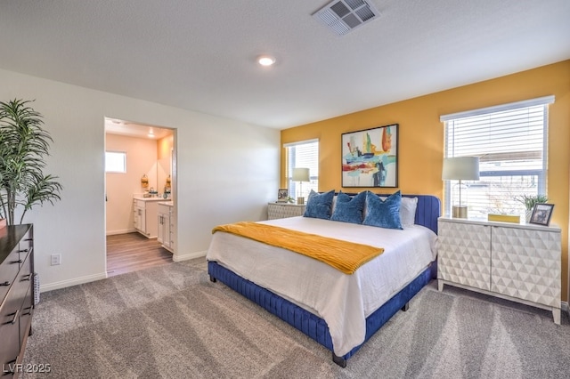 6521 Cinnamon Hazelnut St Lot 91, North Las Vegas, NV 89084 - carpeted bedroom with baseboards and ensuite bath