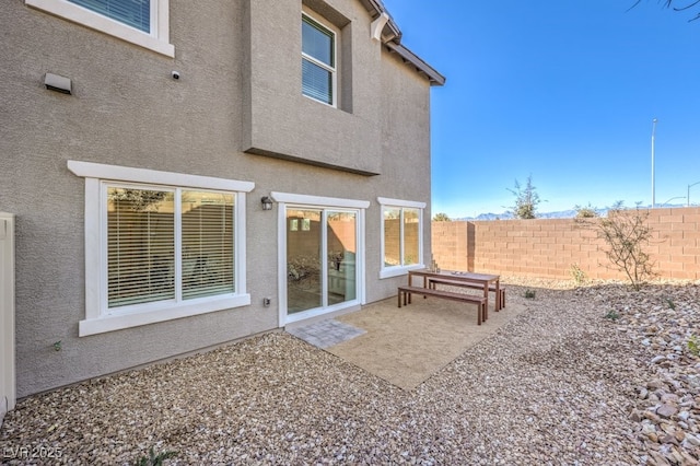 6521 Cinnamon Hazelnut St Lot 91, North Las Vegas, NV 89084 - rear view of house with stucco siding, fence, and a patio area
