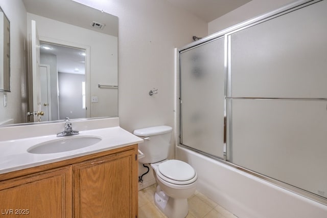 11177 Deluna St, Las Vegas, NV 89141 - bathroom featuring toilet, tile patterned floors, vanity, and combined bath / shower with glass door