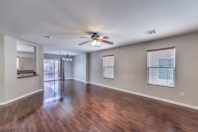 11177 Deluna St, Las Vegas, NV 89141 - empty room with ceiling fan, baseboards, dark wood-style floors, and a chandelier