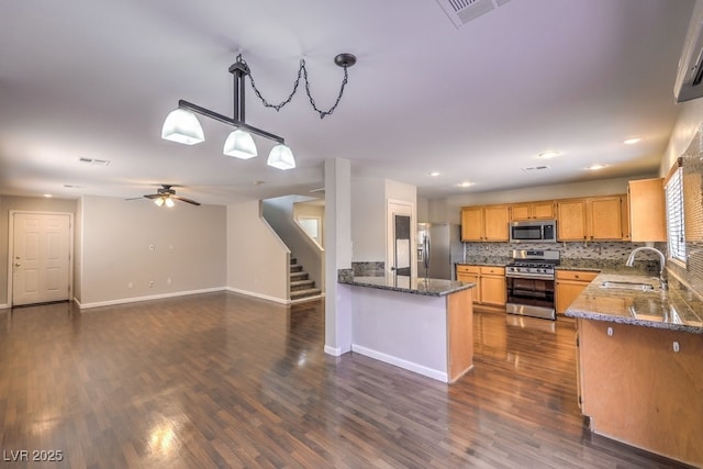 11177 Deluna St, Las Vegas, NV 89141 - kitchen featuring stainless steel appliances, a sink, dark wood finished floors, tasteful backsplash, and recessed lighting