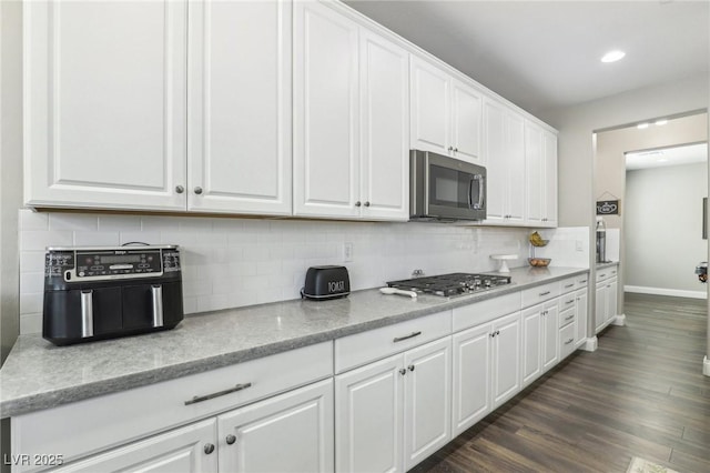 716 Cadence View Way, Henderson, NV 89011 - kitchen featuring stainless steel appliances, white cabinets, baseboards, backsplash, and recessed lighting