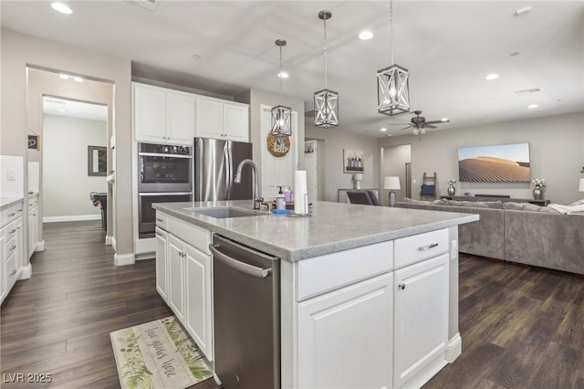 716 Cadence View Way, Henderson, NV 89011 - kitchen featuring a sink, appliances with stainless steel finishes, recessed lighting, open floor plan, and dark wood-type flooring